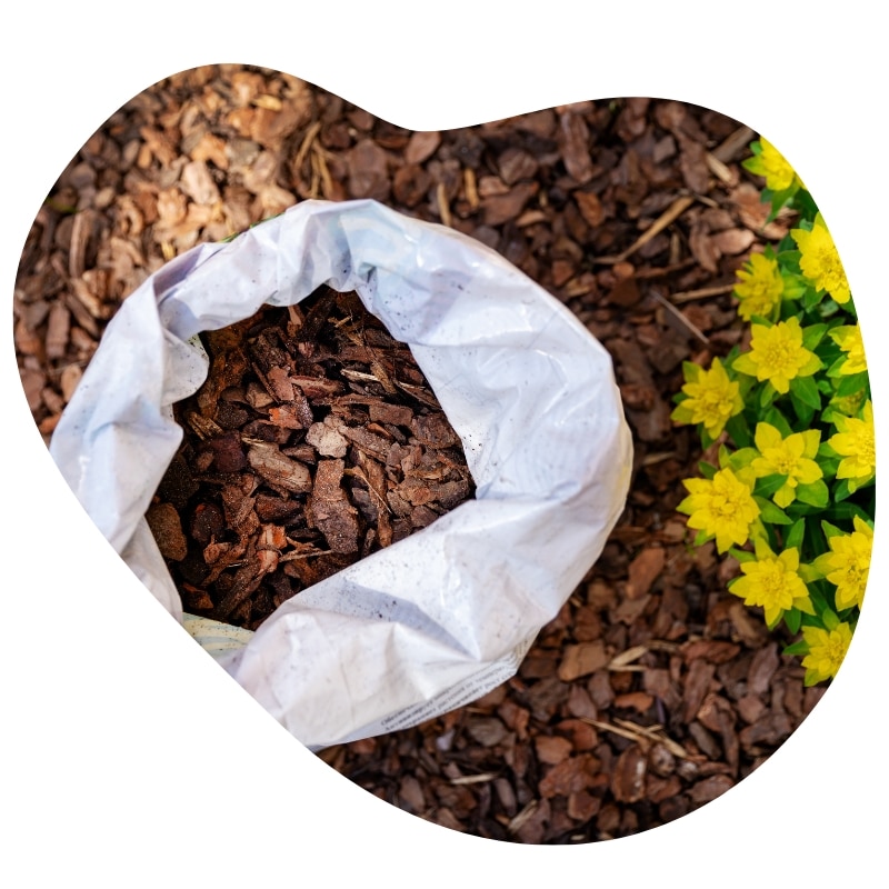 Bag of bark mulch ready for garden bed use, ideal for professional tree mulching Melbourne around flower beds.