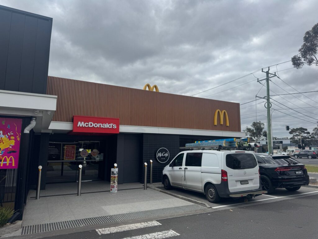 McDonald’s storefront with vehicles parked during storm damage repairs.