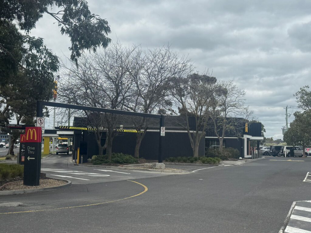 McDonald’s drive-thru surrounded by trees and storm debris.